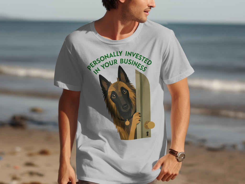 Grey t-shirt with a Belgian Malinois peeking around a door, text reads "Personally Invested in Your Business."