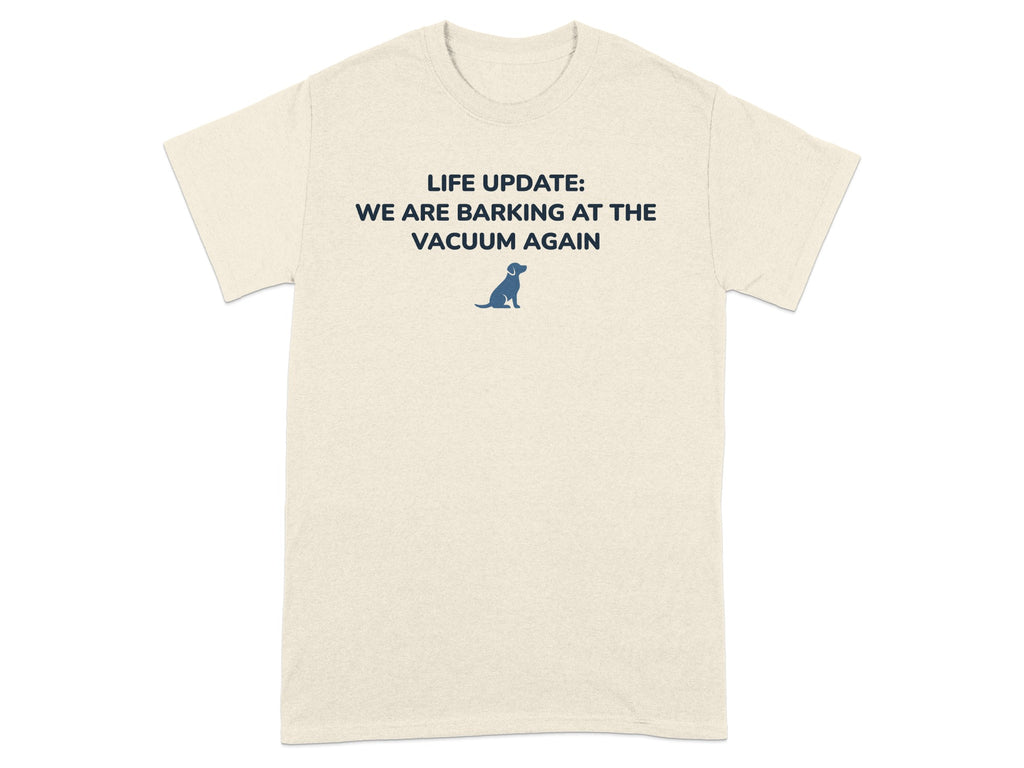 Cream t-shirt with text "LIFE UPDATE: WE ARE BARKING AT THE VACUUM AGAIN" and a small dog graphic.
