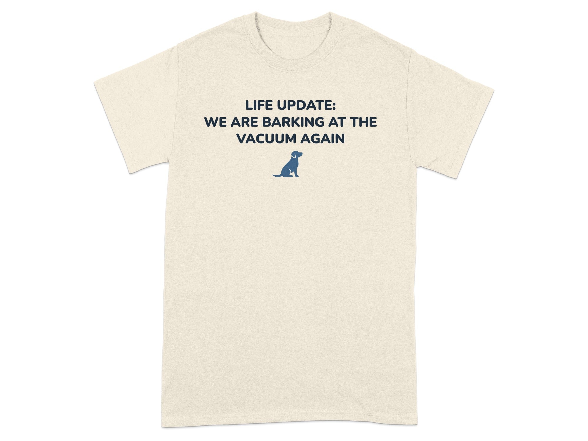 Cream t-shirt with text "LIFE UPDATE: WE ARE BARKING AT THE VACUUM AGAIN" and a small dog graphic.