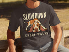 Dark grey t-shirt with text "SLOW DOWN ENJOY WALKS" and a sad Basset Hound.