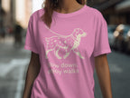 Pink t-shirt with a cream line drawing of a dog on a leash and text.