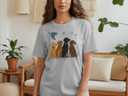 Light gray t-shirt with four cartoon dogs sitting in a row.