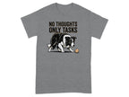 Black and white dog with ball and text "NO THOUGHTS ONLY TASKS" on gray t-shirt.
