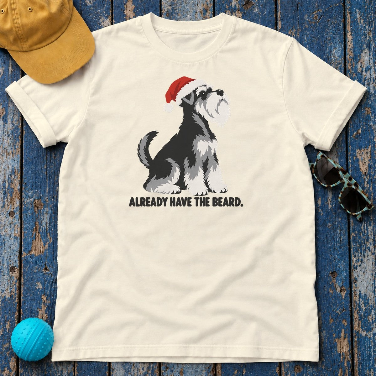 Already Have the Beard Sitting Santa Schnauzer T-Shirt in Natural - flat lay