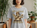 T-shirt with dog riding a winged goose and text "Off to commit Shenanigans".
