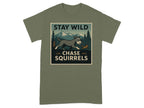 Green t-shirt with "STAY WILD CHASE SQUIRRELS" text and illustration of dog chasing squirrel.