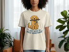 Beige t-shirt with cartoon dog holding stick and text "I just need to hold something".
