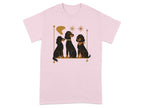 Three black dogs with stylized features sit on a shelf against a pink t-shirt.