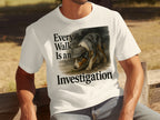 White t-shirt with a graphic of a dog wearing a detective hat and the text "Every Walk Is an Investigation".