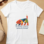 White v-neck t-shirt with a colorful abstract dog graphic and text "feral little creature, perfectly formed."