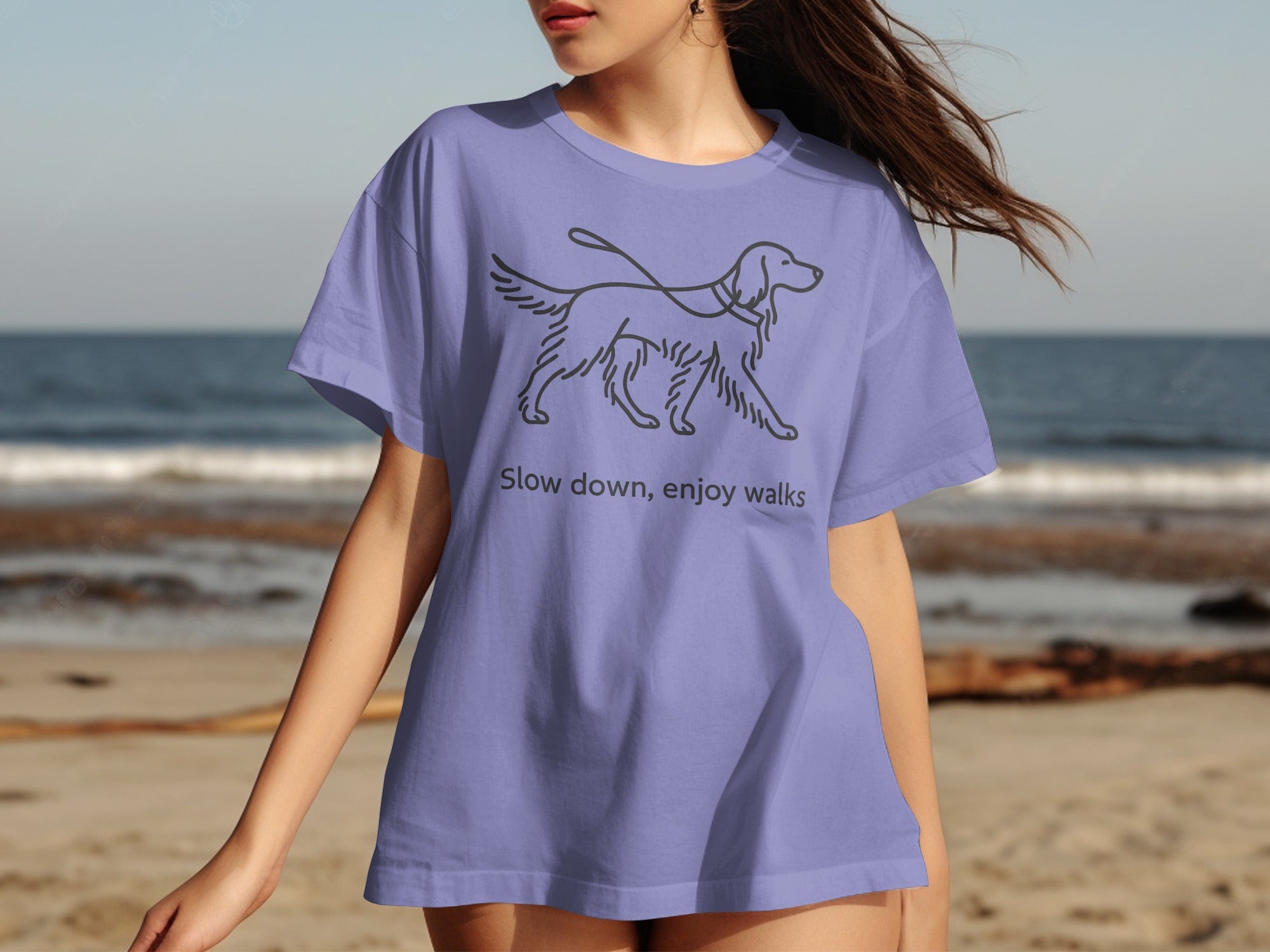 Lilac t-shirt with line drawing of a walking dog and text "Slow down, enjoy walks."