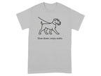 Grey t-shirt with line drawing of a dog on a leash and text "Slow down, enjoy walks".