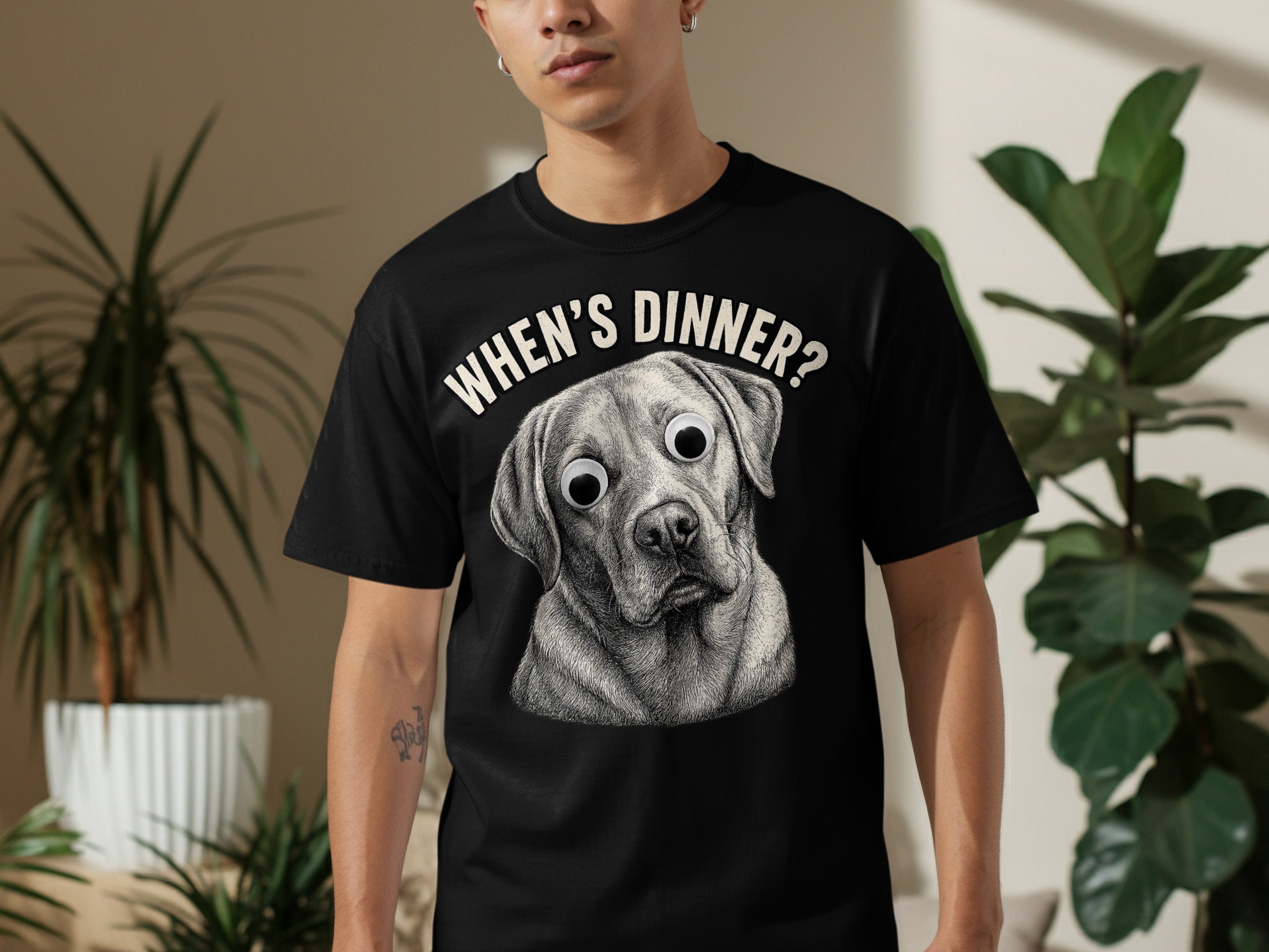 Black t-shirt with sketch of wide-eyed dog and text "WHEN'S DINNER?".