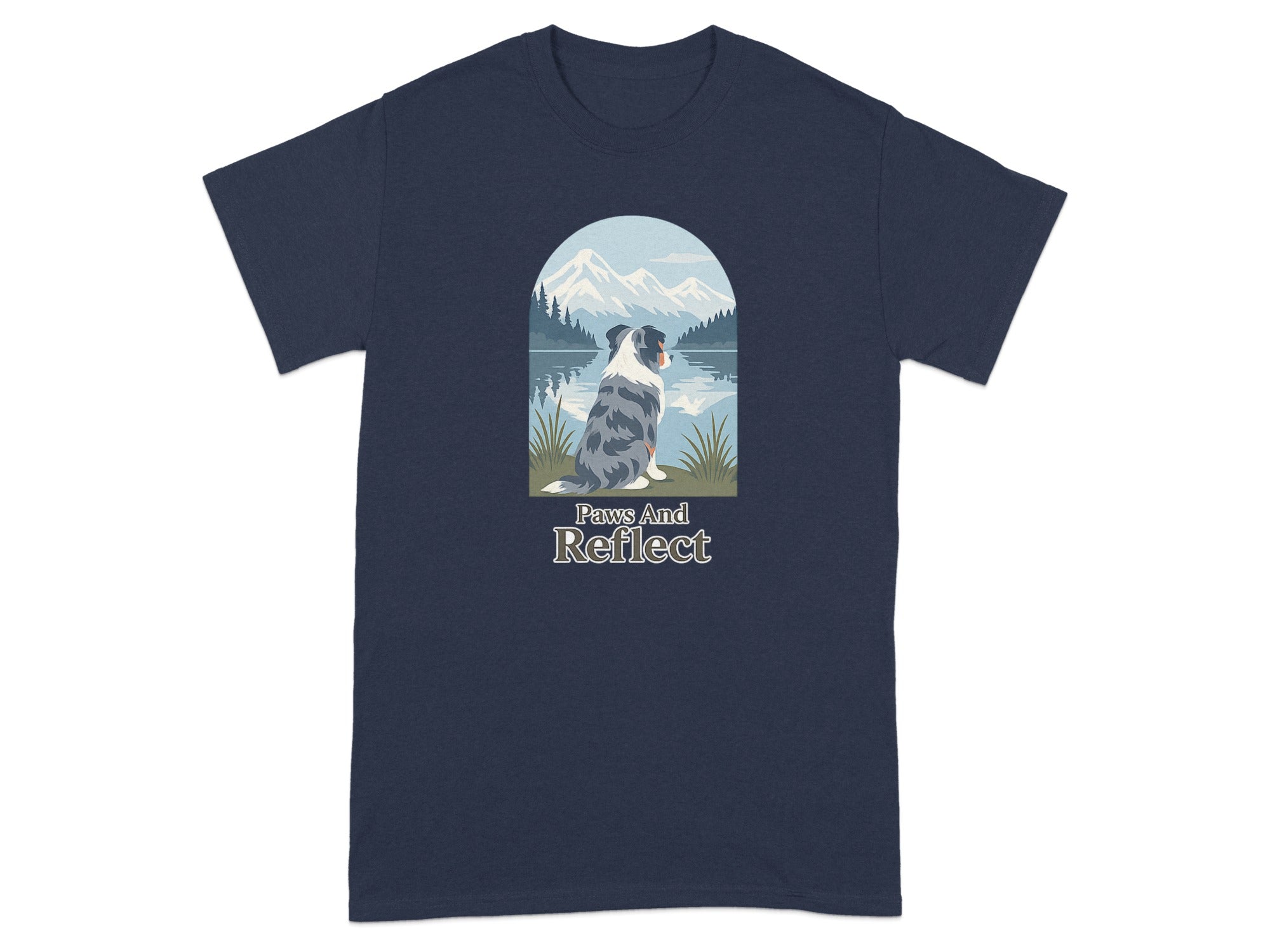 Blue and gray dog sitting by a lake with mountains and forest behind.