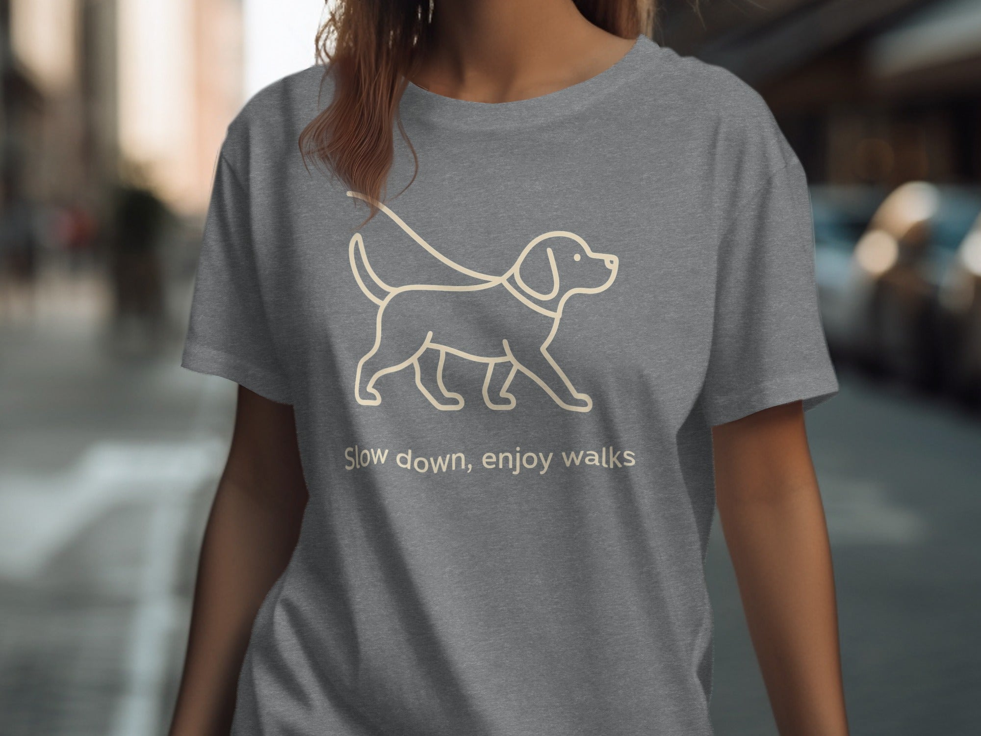 Grey t-shirt with a line drawing of a dog and the text "Slow down, enjoy walks."