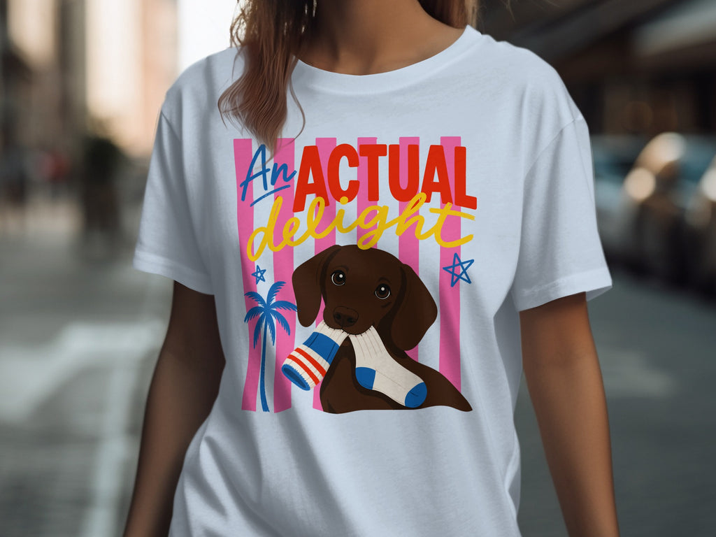 T-shirt with a dog holding a striped sock, text "AN ACTUAL DELIGHT".