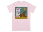 Pink t-shirt with illustration of brown dog, sun, clouds, and text "LAB DAYS ARE THE BEST DAYS".