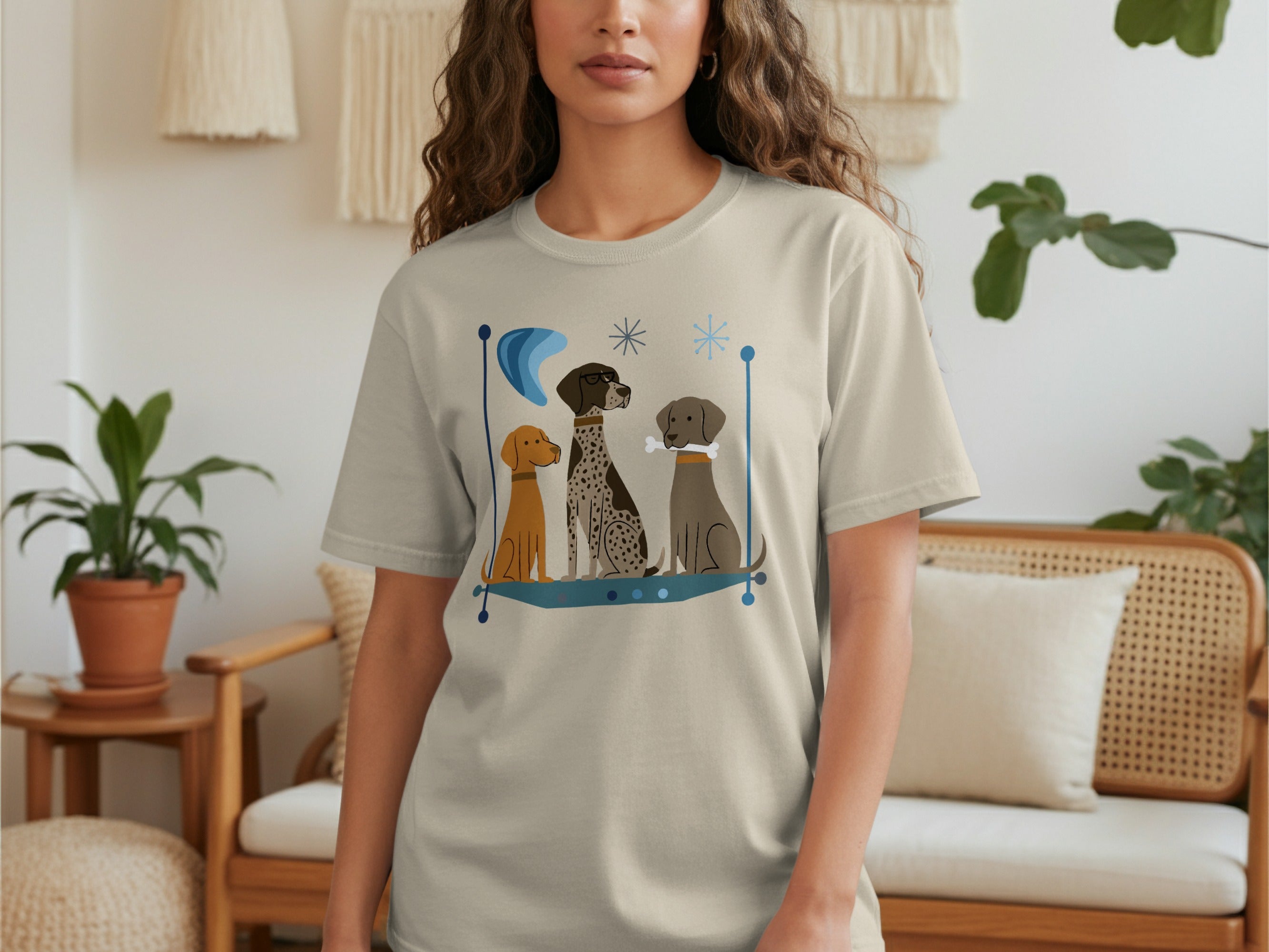Light beige t-shirt with three cartoon dogs in a framed design.