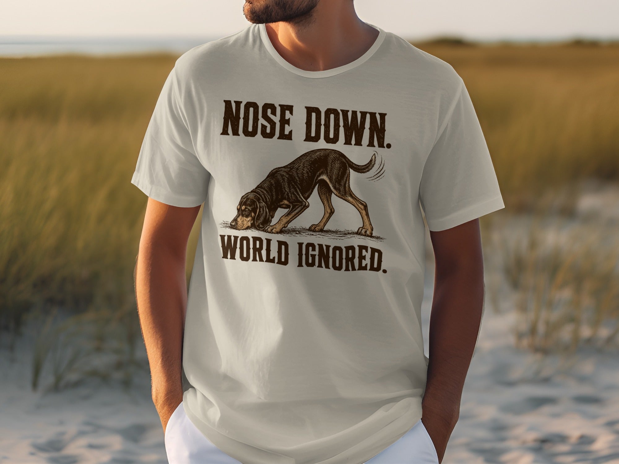 Light gray t-shirt with "Nose Down. World Ignored." text and a dog sniffing the ground.