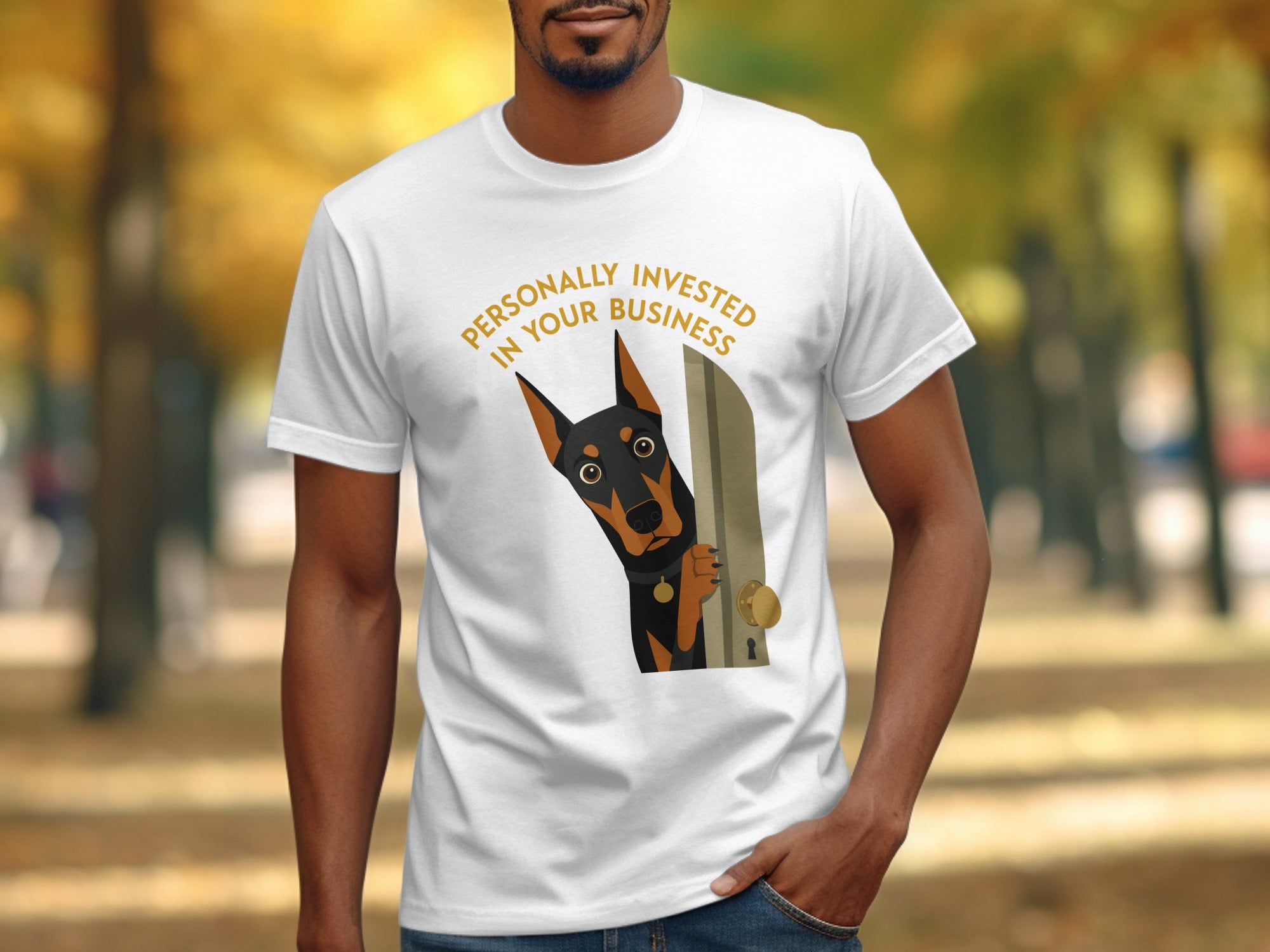 White t-shirt with a cartoon Doberman peeking through a door, text reads "Personally Invested in Your Business".