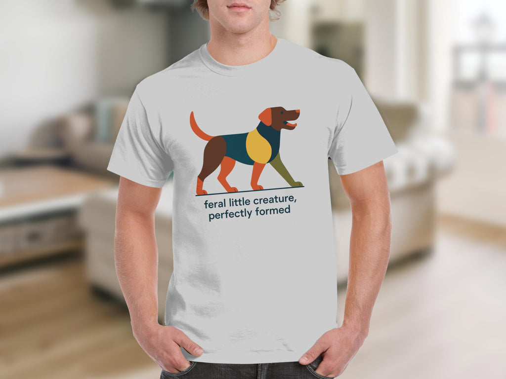White t-shirt with abstract dog graphic and text "feral little creature, perfectly formed."