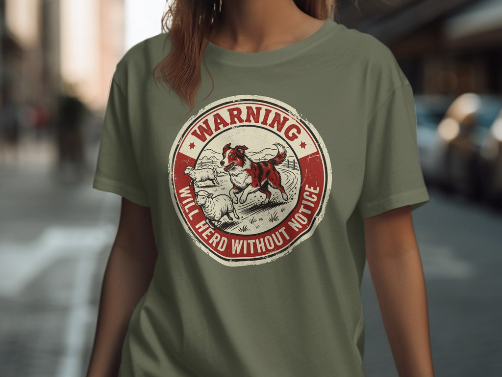 Circular logo with a dog herding sheep and text "Warning Will Herd Without Notice."