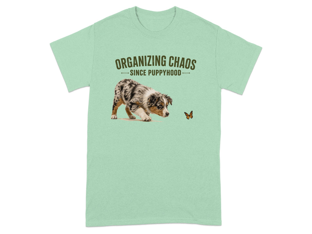 Light green t-shirt with a puppy chasing a butterfly and the text "Organizing Chaos Since Puppyhood."