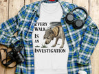 White t-shirt with "Every Walk Is An Investigation" and dog graphic.