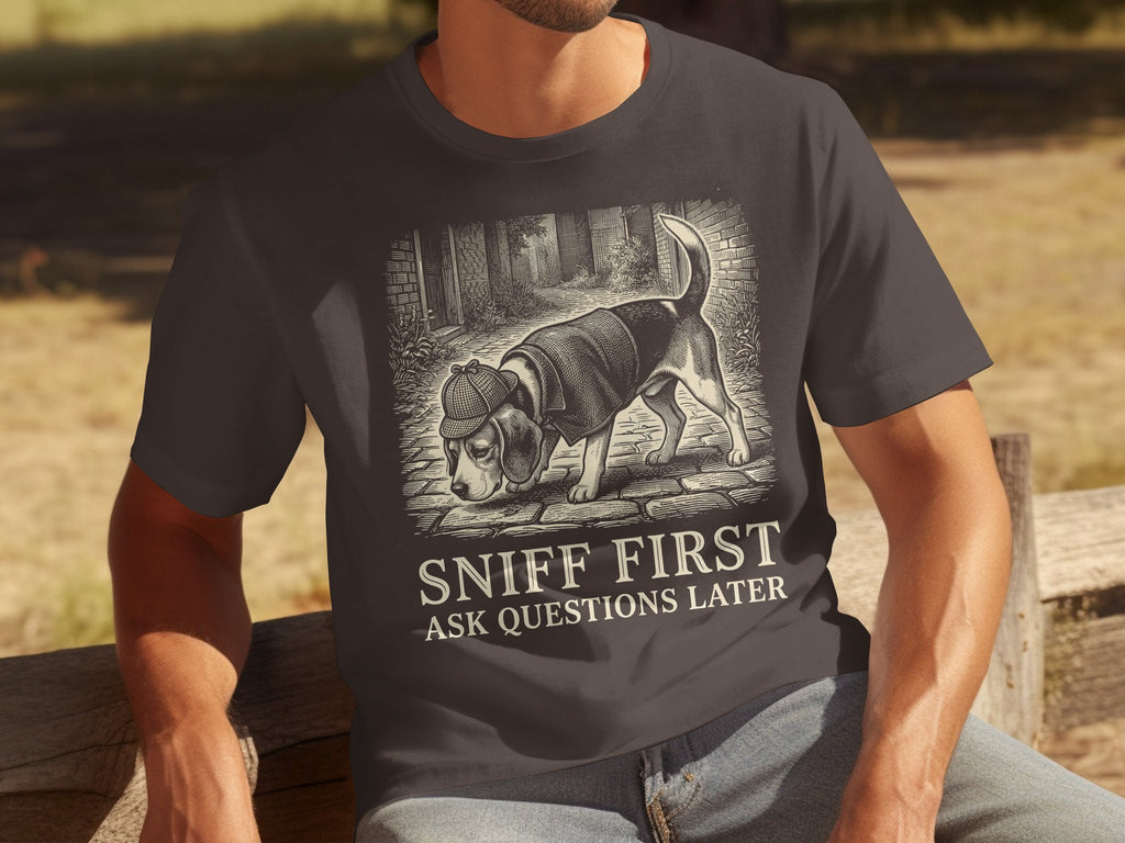 Dark t-shirt with a dog in a detective hat and the text "SNIFF FIRST ASK QUESTIONS LATER".