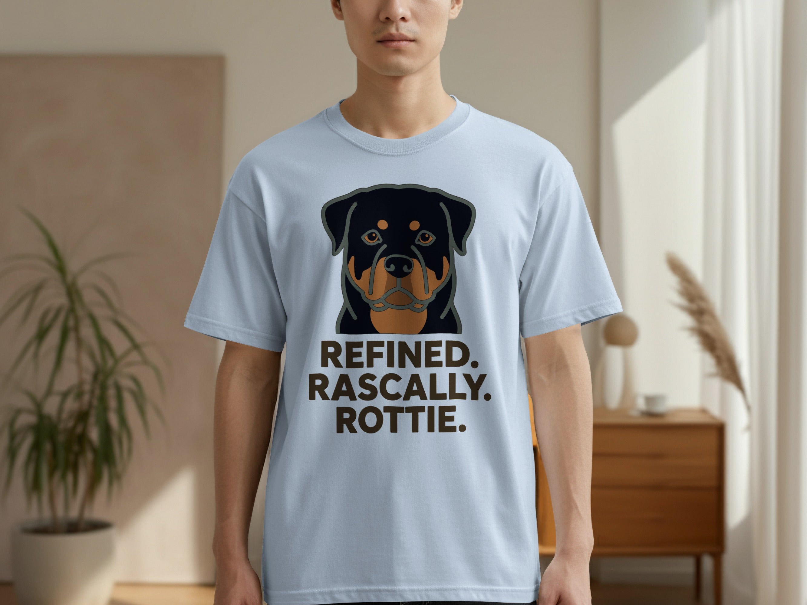 Light blue t-shirt with a Rottweiler's face and the text "Refined. Rascally. Rottie."