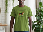 Green t-shirt with a dog and text "PERSONALLY VICTIMIZED BY BARKING AT ABSOLUTELY NOTHING".