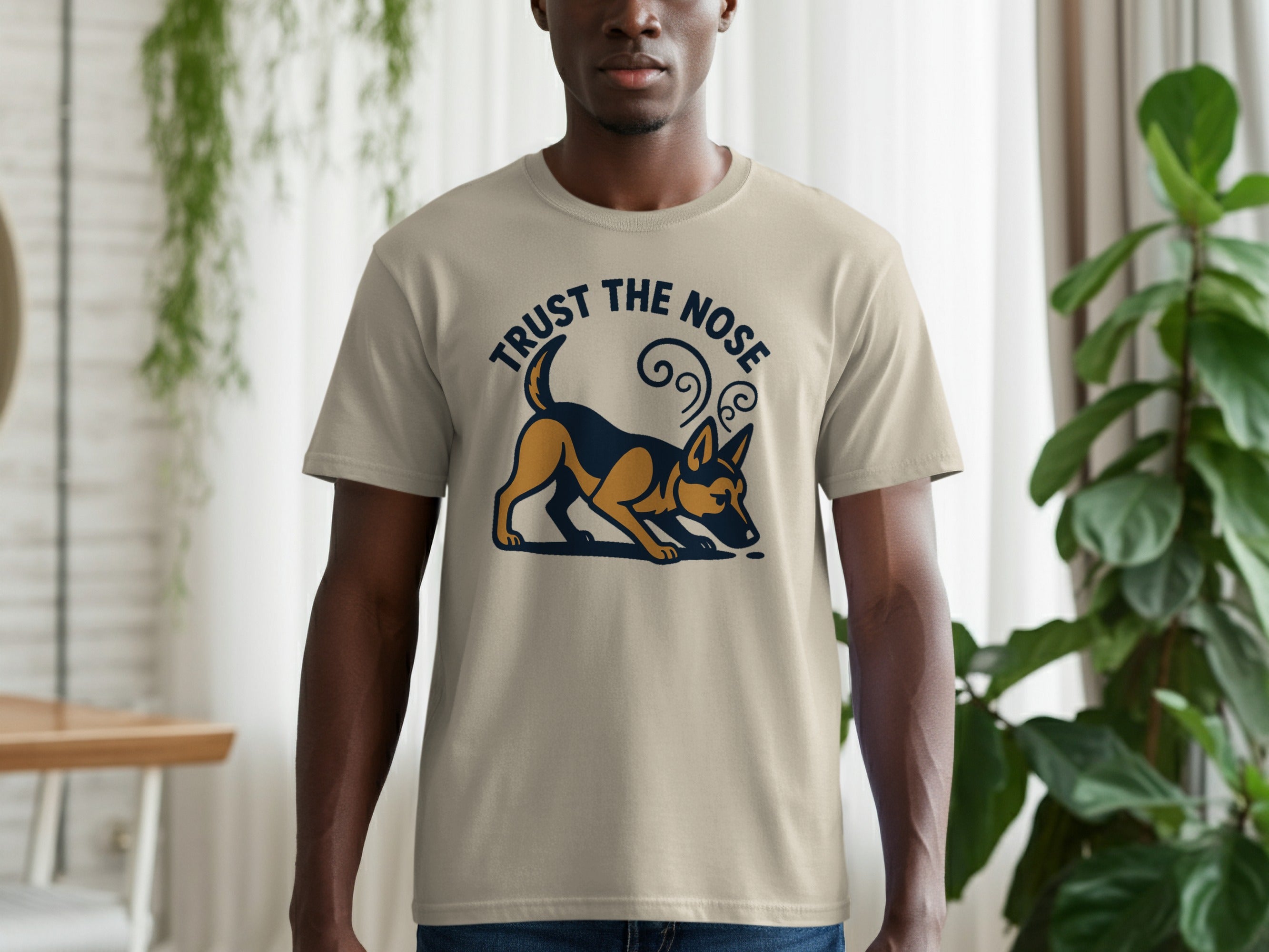 Tan t-shirt with dark blue and gold "Trust the Nose" text and dog graphic.