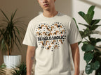 Beagle faces arranged in a heart shape on a cream t-shirt.