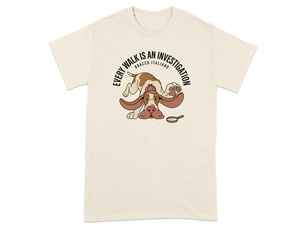 Beige t-shirt with a cartoon dog wearing a detective hat and a magnifying glass.