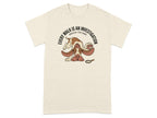 Beige t-shirt with a cartoon dog wearing a detective hat and a magnifying glass.