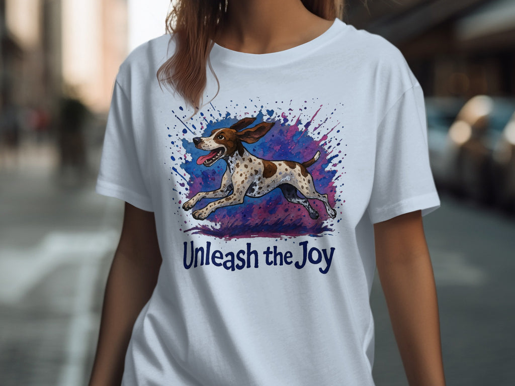 White t-shirt with a running spotted dog and "Unleash the Joy" text.
