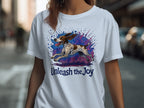 White t-shirt with a running spotted dog and "Unleash the Joy" text.
