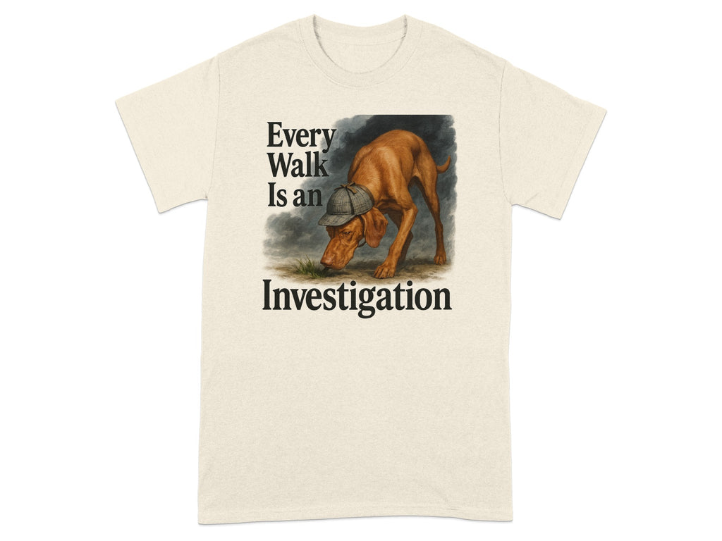 Tan t-shirt with illustration of dog wearing hat,text reads "Every Walk Is an Investigation".