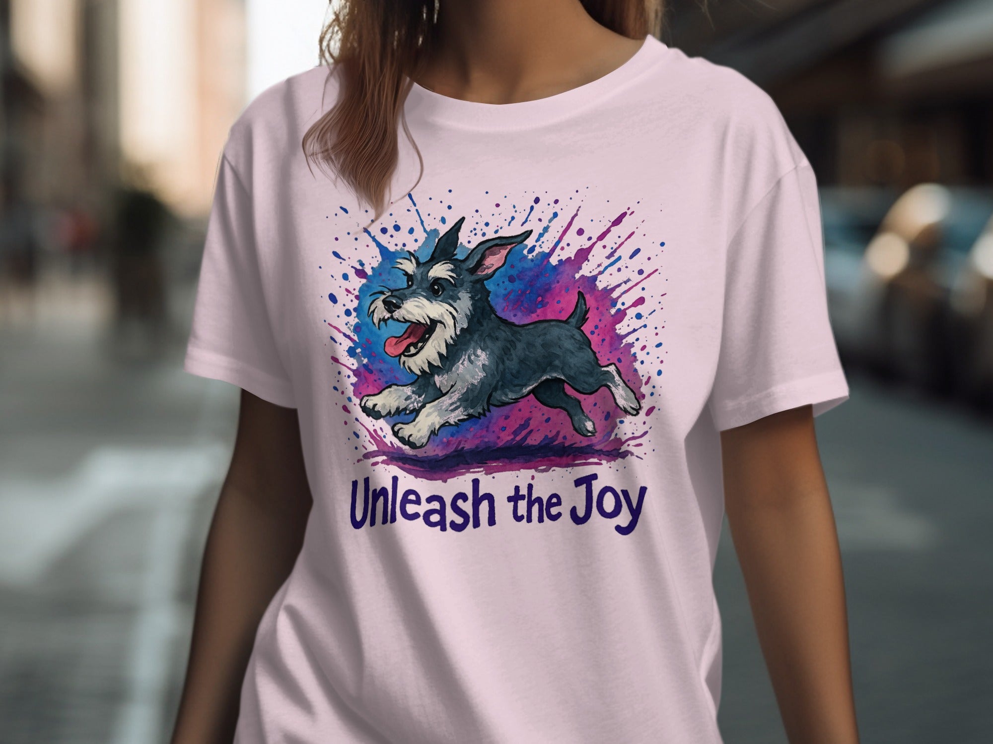 T-shirt features a running schnauzer with colorful paint splatters and text "Unleash the Joy".