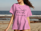 Pink t-shirt with a dachshund graphic and text "Slow down, enjoy walks."
