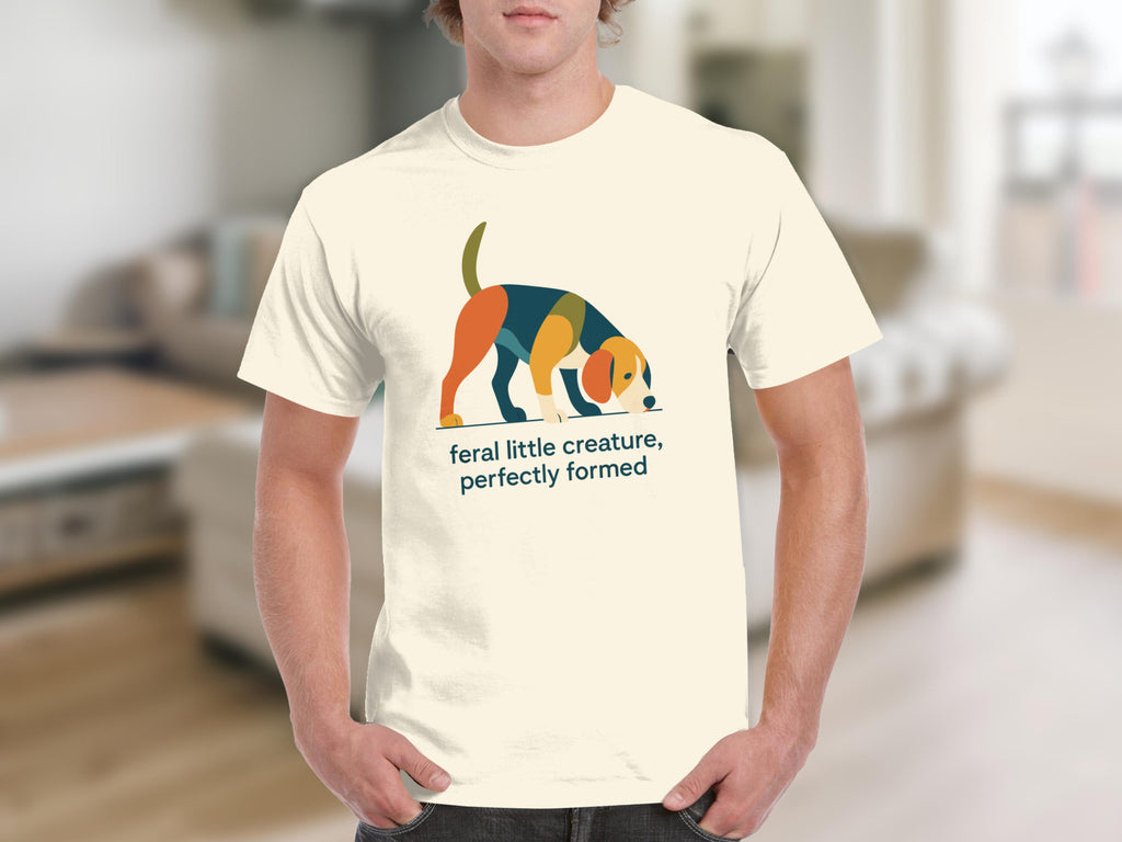 T-shirt with graphic of colorful abstract dog and text "feral little creature, perfectly formed".