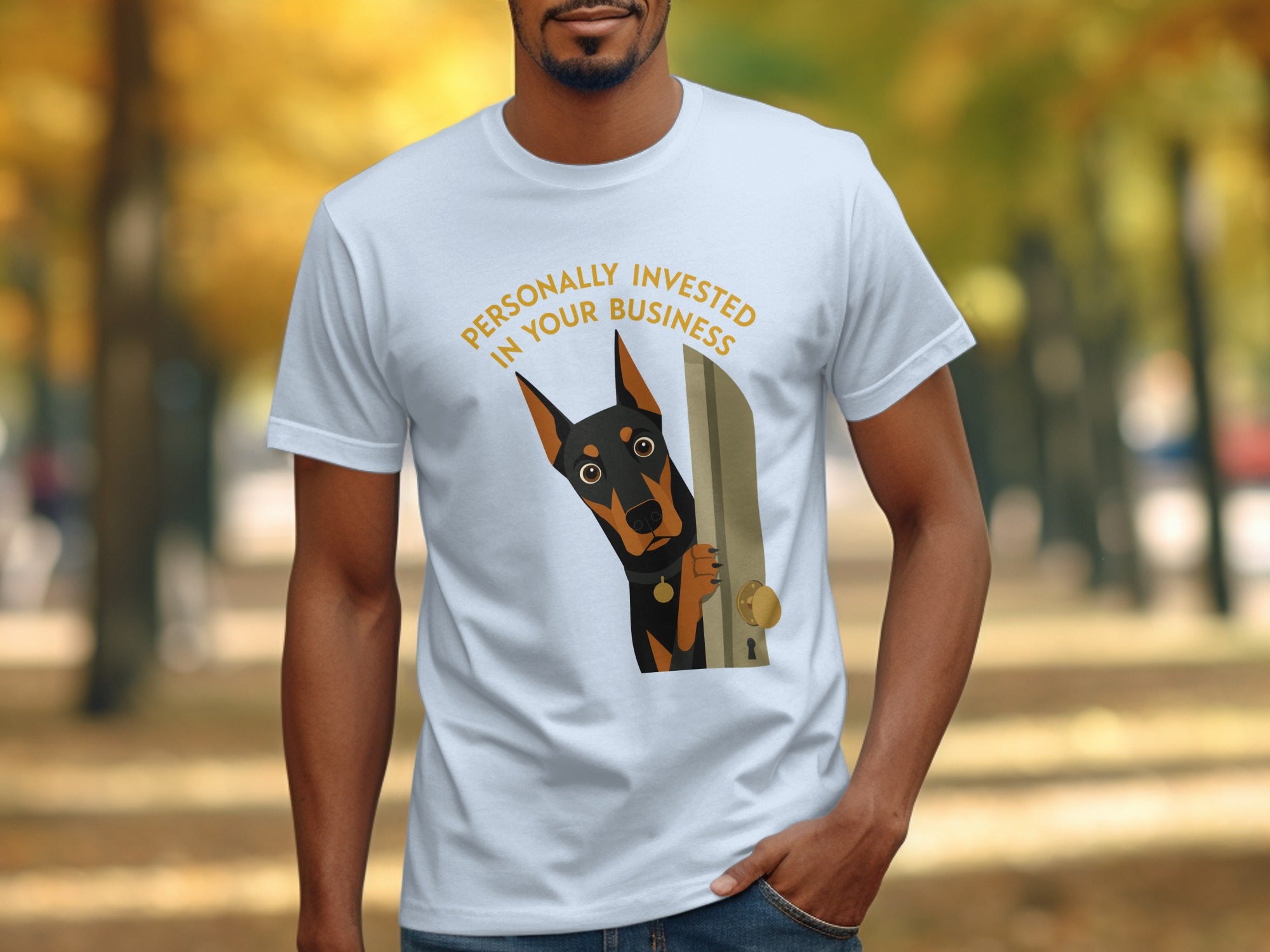 Doberman peeking through doorway on white t-shirt with text.