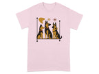 Pink t-shirt with graphic of three German Shepherd dogs sitting on a shelf with abstract shapes.