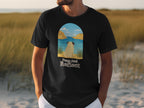 Black t-shirt with pug at arch overlooking water, text "Paws And Reflect".