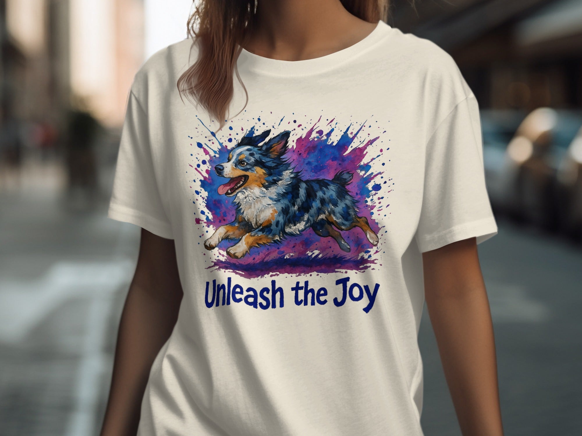 White t-shirt with watercolor dog and "Unleash the Joy" text.