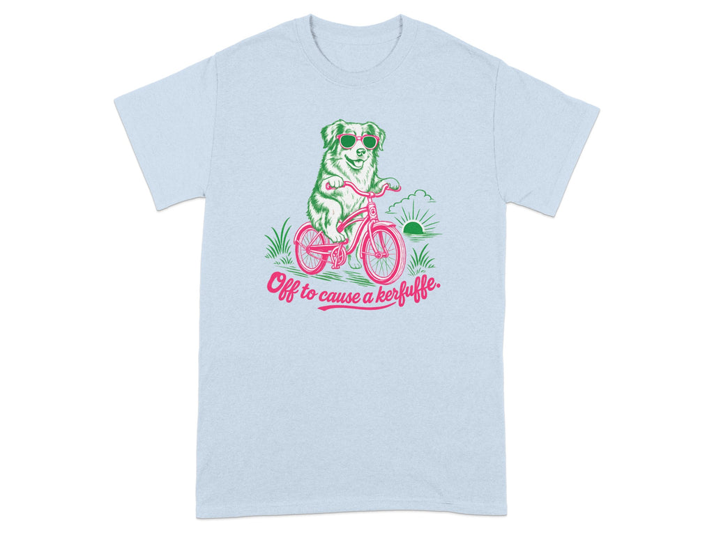 Light blue t-shirt with a dog in sunglasses riding a bicycle, text reads "Off to cause a kerfuffle."