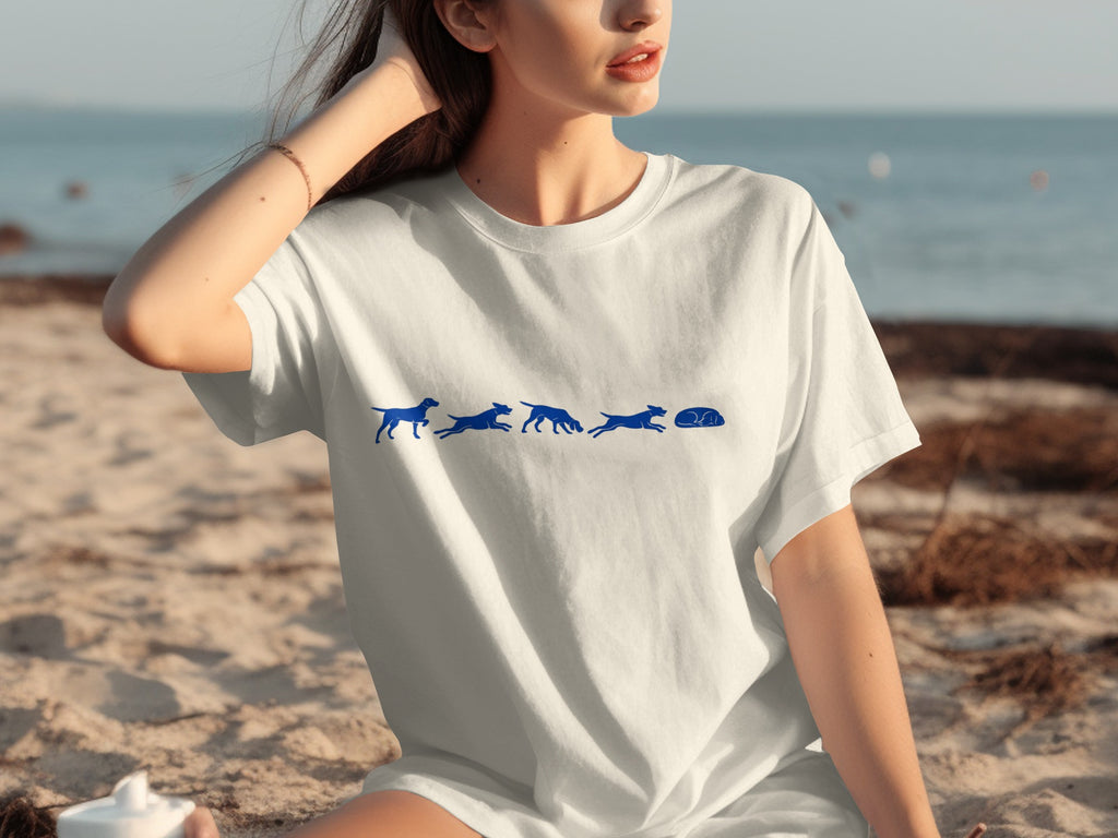 White t-shirt with blue dog graphic showcasing a sequence of poses on a beach.