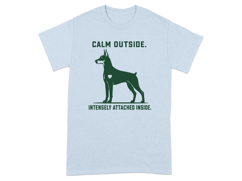 Light blue t-shirt with Doberman silhouette and text "CALM OUTSIDE. INTENSELY ATTACHED INSIDE."