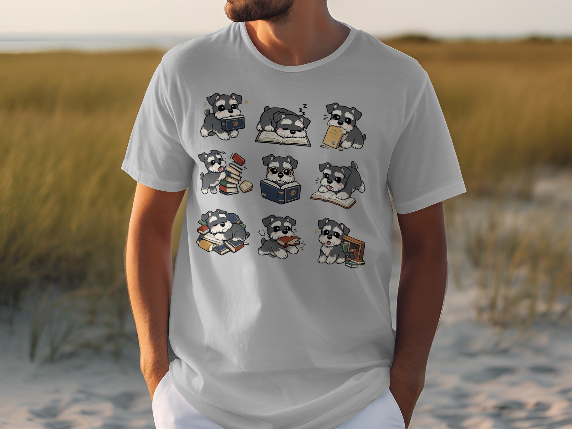 Grey t-shirt with a nine-panel cartoon illustration of schnauzer puppies interacting with books.