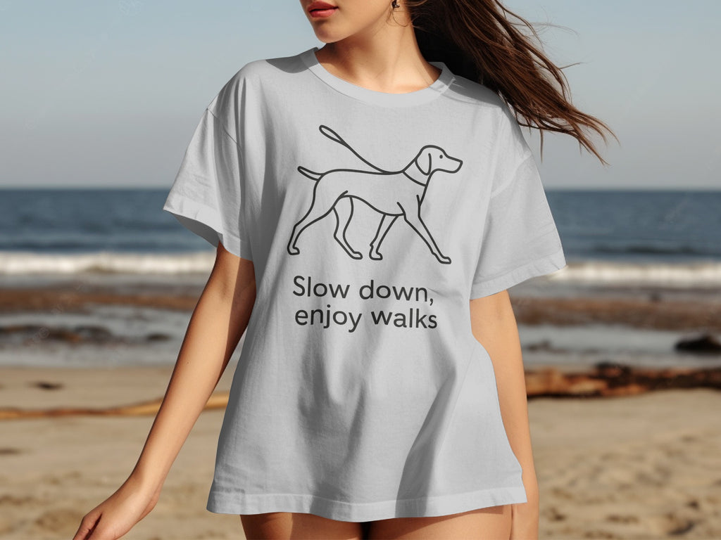 Light grey t-shirt with black line drawing of a dog on a leash and text.